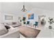 Open-concept living room features a large sofa and view to kitchen at 101 Saddlehorn Ct, Woodstock, GA 30188
