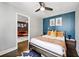 Cozy bedroom with a blue accent wall, comfortable bed, and stylish decor at 215 Piedmont Ne Ave # 1509, Atlanta, GA 30308