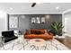 Stylish living room featuring an orange sofa, unique rug, and modern decor at 215 Piedmont Ne Ave # 1509, Atlanta, GA 30308