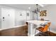 This living room has a bar area with two orange chairs and faces the main entrance at 215 Piedmont Ne Ave # 1509, Atlanta, GA 30308
