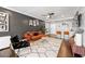Spacious living room with hardwood floors, a ceiling fan, a breakfast bar, and modern decor at 215 Piedmont Ne Ave # 1509, Atlanta, GA 30308