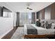 Modern main bedroom with a city view, accent wall, and comfortable bedding at 215 Piedmont Ne Ave # 1509, Atlanta, GA 30308