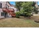 Backyard view with a wooden deck, green grass, and mature trees, offering a relaxing outdoor space at 2810 Olde Town Park Dr, Norcross, GA 30071