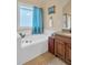 Bathroom with jacuzzi tub, granite countertop, and natural light at 2810 Olde Town Park Dr, Norcross, GA 30071