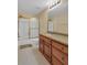 Bathroom features wooden cabinets, granite countertop, a shower, a toilet, and tile floors at 2810 Olde Town Park Dr, Norcross, GA 30071