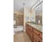 Bathroom features wood cabinets, granite countertop, a shower, a toilet, and tile floors at 2810 Olde Town Park Dr, Norcross, GA 30071
