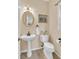 Bathroom with pedestal sink, oval mirror, and decorative accents at 2810 Olde Town Park Dr, Norcross, GA 30071