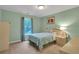 A bright bedroom with a light blue bedspread and walls, a window, and a neutral-toned carpet at 2810 Olde Town Park Dr, Norcross, GA 30071