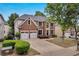 Beautiful two-story brick home with a well-manicured lawn and a two-car garage and long driveway at 2810 Olde Town Park Dr, Norcross, GA 30071