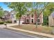 Charming two-story brick home with a two-car garage and landscaped front yard near sidewalk at 2810 Olde Town Park Dr, Norcross, GA 30071