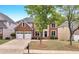 Charming two-story brick home featuring a two-car garage and a well-maintained front yard at 2810 Olde Town Park Dr, Norcross, GA 30071