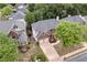 Aerial view of a charming two-story home with a two-car garage and mature trees at 2810 Olde Town Park Dr, Norcross, GA 30071