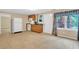 Features a kitchenette with white appliances, oak cabinets, tile floors, and a view to the backyard at 2810 Olde Town Park Dr, Norcross, GA 30071
