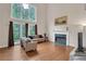 Living room featuring large windows, fireplace, hardwood floors, and neutral paint at 2810 Olde Town Park Dr, Norcross, GA 30071