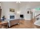 Open-concept living room has fireplace, hardwood floors, and ample natural light at 2810 Olde Town Park Dr, Norcross, GA 30071