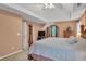 Main bedroom with tray ceiling, ceiling fan, and ensuite bath at 2810 Olde Town Park Dr, Norcross, GA 30071