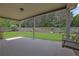 Inviting covered back patio with a swing overlooking the fenced backyard at 3425 Sweet Basil Ln, Loganville, GA 30052