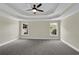Expansive main bedroom features large windows, tray ceiling with fan, and neutral paint at 3425 Sweet Basil Ln, Loganville, GA 30052