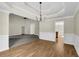 Open dining room with hardwood floors, wainscoting, and tray ceiling at 3425 Sweet Basil Ln, Loganville, GA 30052