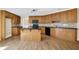 Spacious kitchen features wooden cabinets, an island with granite countertop, and black appliances at 3425 Sweet Basil Ln, Loganville, GA 30052