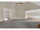 Large living area with gray carpet, high ceilings, and ample natural light at 3425 Sweet Basil Ln, Loganville, GA 30052