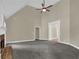Open living area with high ceilings, a ceiling fan, and a brick fireplace at 3425 Sweet Basil Ln, Loganville, GA 30052