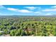 An aerial view shows the surrounding area of the property, with lush trees and a location pin to identify at 3951 Lindley Dr, Powder Springs, GA 30127