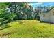 Expansive backyard featuring lush green lawn, mature trees, and landscaping for outdoor enjoyment at 3951 Lindley Dr, Powder Springs, GA 30127