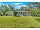 Spacious backyard featuring lush green grass, landscaping, and a charming white brick home at 3951 Lindley Dr, Powder Springs, GA 30127