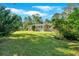 Lush backyard featuring a well-maintained lawn, mature trees, and blooming shrubs, creating a serene oasis at 3951 Lindley Dr, Powder Springs, GA 30127