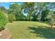 Expansive backyard with lush green grass and mature trees, offering privacy and a park-like setting at 3951 Lindley Dr, Powder Springs, GA 30127