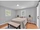 Cozy bedroom features a decorative rug, bedside table, and a window view of the outdoors at 3951 Lindley Dr, Powder Springs, GA 30127