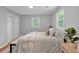 Bedroom with decorative rug, bedside table, and large window that offers a view of the outdoors at 3951 Lindley Dr, Powder Springs, GA 30127