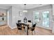 Dining area with modern chandelier, table setting, and adjacent access to outdoor space at 3951 Lindley Dr, Powder Springs, GA 30127