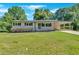 Charming single-story home boasts a covered front porch, carport, and lush lawn at 3951 Lindley Dr, Powder Springs, GA 30127