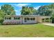 Charming single-story home with a well-manicured lawn and a covered parking area, offering a blend of comfort and style at 3951 Lindley Dr, Powder Springs, GA 30127