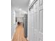 Hallway leading to dining area with view of the kitchen and stainless steel refrigerator and pantry at 3951 Lindley Dr, Powder Springs, GA 30127