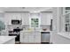 Well-lit kitchen with white cabinets, quartz countertops, and modern stainless steel appliances at 3951 Lindley Dr, Powder Springs, GA 30127