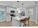 Modern kitchen with white cabinets, stainless steel appliances, and a stylish island with seating at 3951 Lindley Dr, Powder Springs, GA 30127