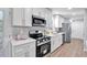 Bright kitchen featuring white cabinets, stainless steel appliances, and quartz countertops at 3951 Lindley Dr, Powder Springs, GA 30127