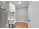 Functional laundry room with sink, storage cabinet, and utility connections for washer and dryer at 3951 Lindley Dr, Powder Springs, GA 30127
