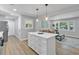 Open floor plan with kitchen island, leading into a cozy living room with natural light at 3951 Lindley Dr, Powder Springs, GA 30127