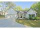 Charming single-story home with a manicured lawn, covered porch, and attached garage, nestled in a wooded location at 453 Mulberry Rock Rd Rd, Temple, GA 30179