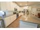 Bright kitchen featuring stainless appliances, granite counters, white cabinets, and an island at 453 Mulberry Rock Rd Rd, Temple, GA 30179
