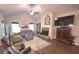Bright living room features a cozy fireplace, plush seating, and natural light, creating an inviting atmosphere at 453 Mulberry Rock Rd Rd, Temple, GA 30179