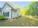 A side yard with lush grass and landscaping provides a serene view to this lovely home at 453 Mulberry Rock Rd Rd, Temple, GA 30179