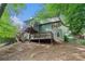 View of the back of a house with a screened porch, deck, and stairs to the yard at 929 Hampton Nw Trl, Lilburn, GA 30047