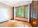 Bedroom with hardwood floors, large window, natural light and custom wood closet doors at 929 Hampton Nw Trl, Lilburn, GA 30047