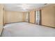 Spacious bedroom with neutral walls, ceiling fan, and two windows providing ample natural light at 929 Hampton Nw Trl, Lilburn, GA 30047
