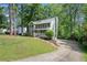 Charming two-story home with a well-manicured front yard and a long driveway at 929 Hampton Nw Trl, Lilburn, GA 30047